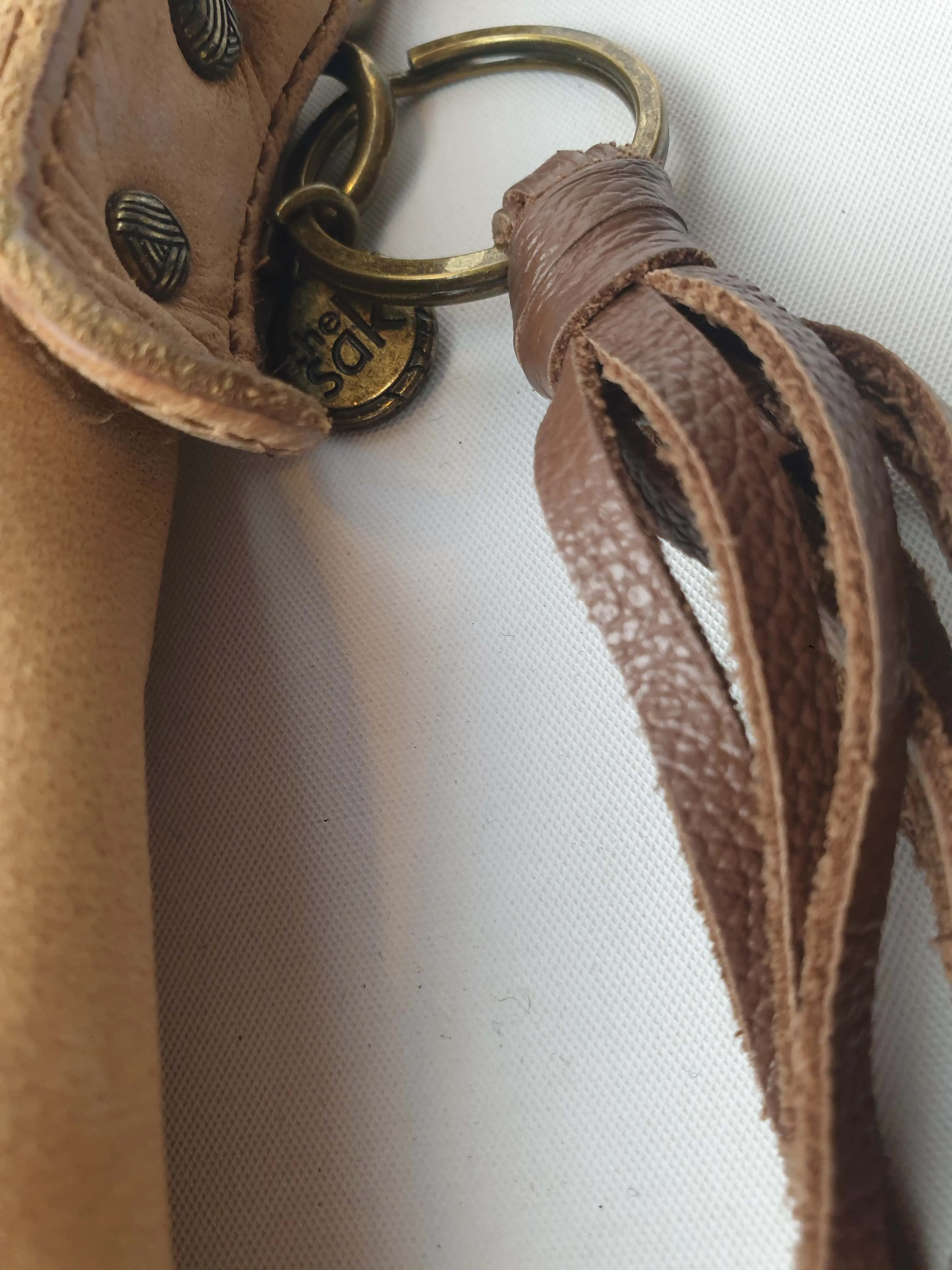 The Sak brown leather cross body bag with subtle floral detail