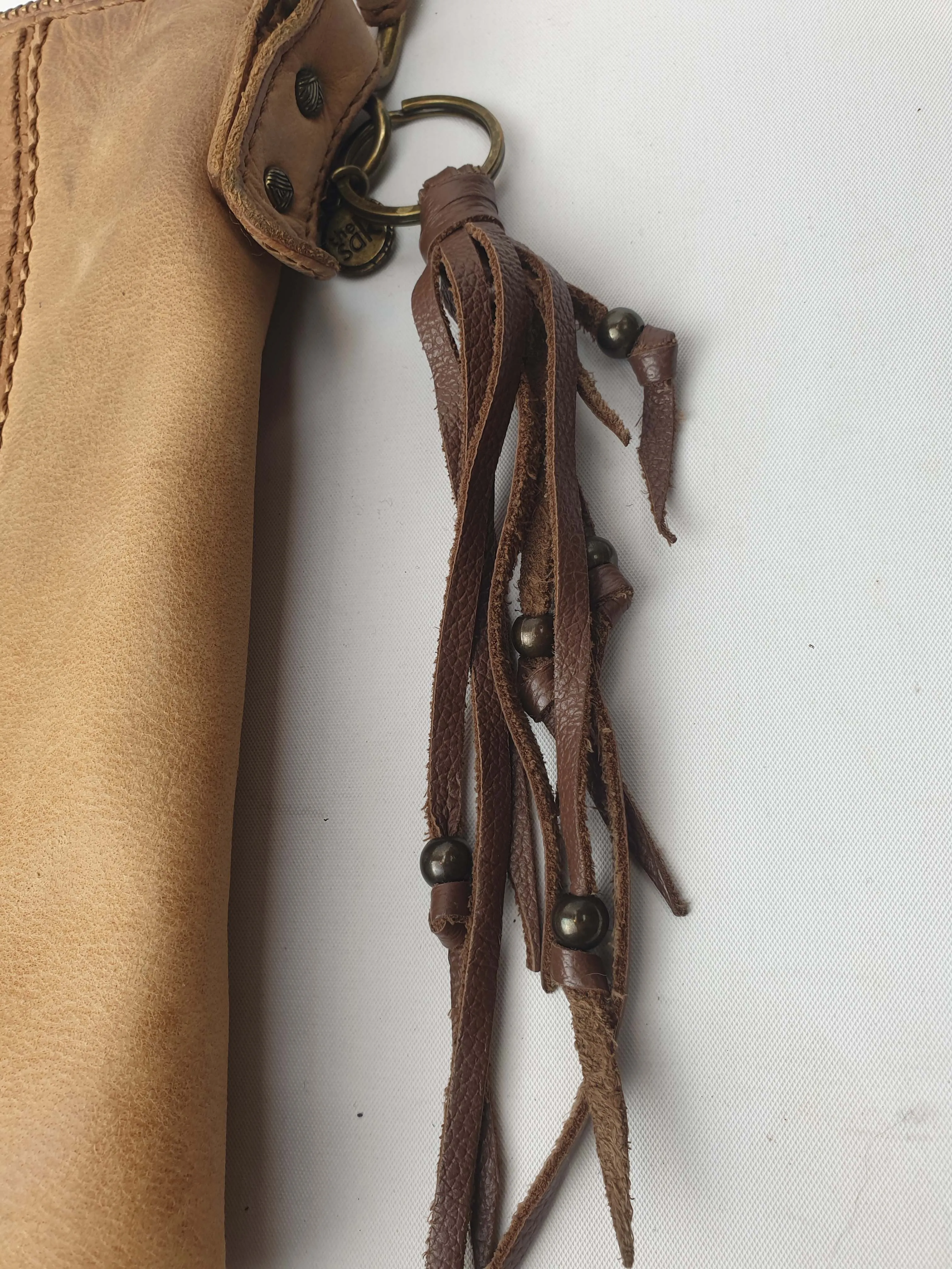 The Sak brown leather cross body bag with subtle floral detail
